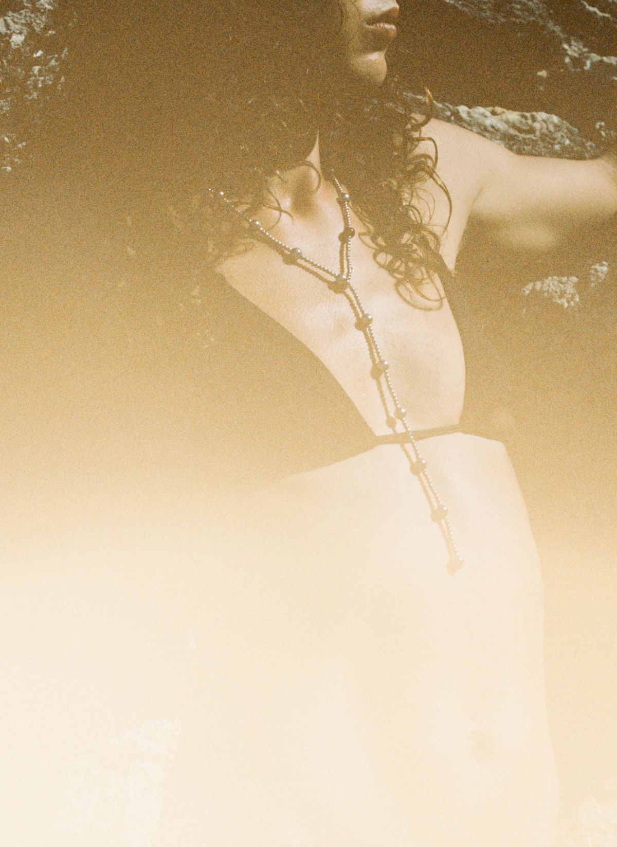 Woman wearing a bikini top and necklace