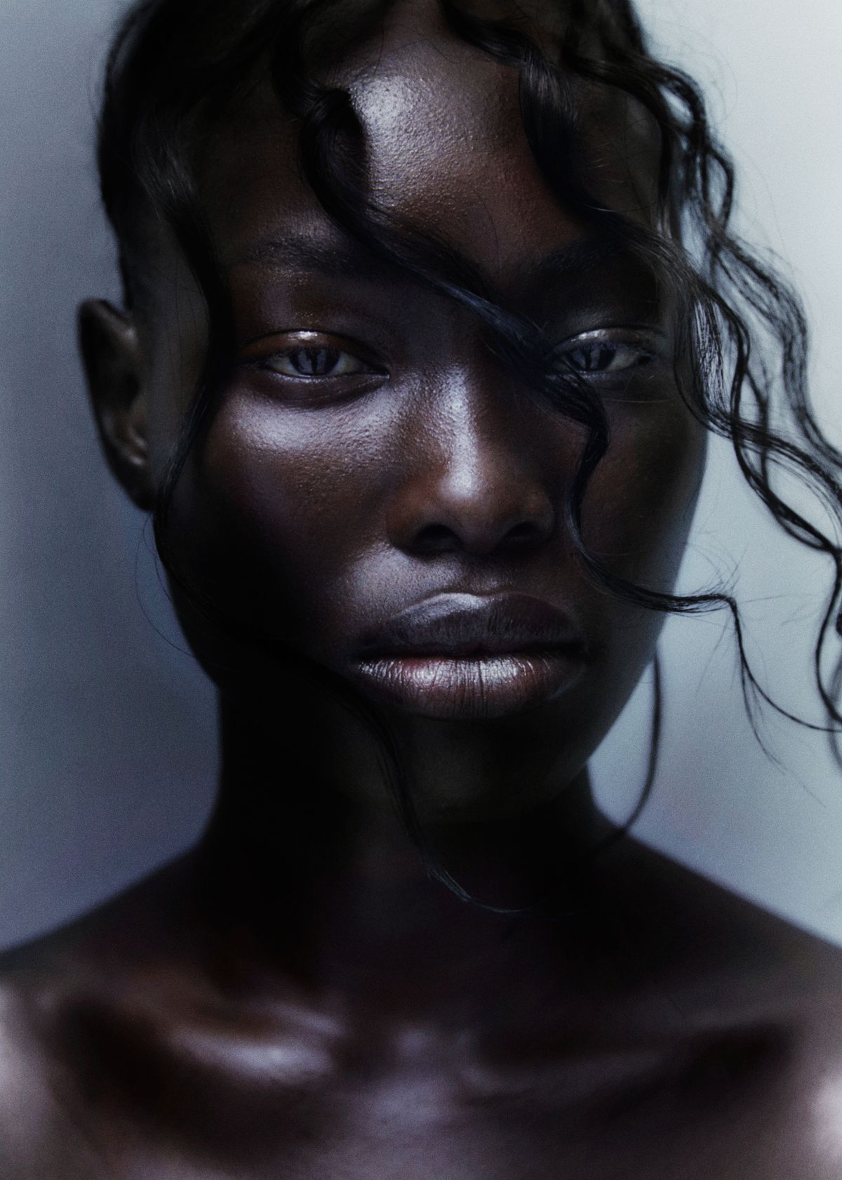 model with hair blowing across her face