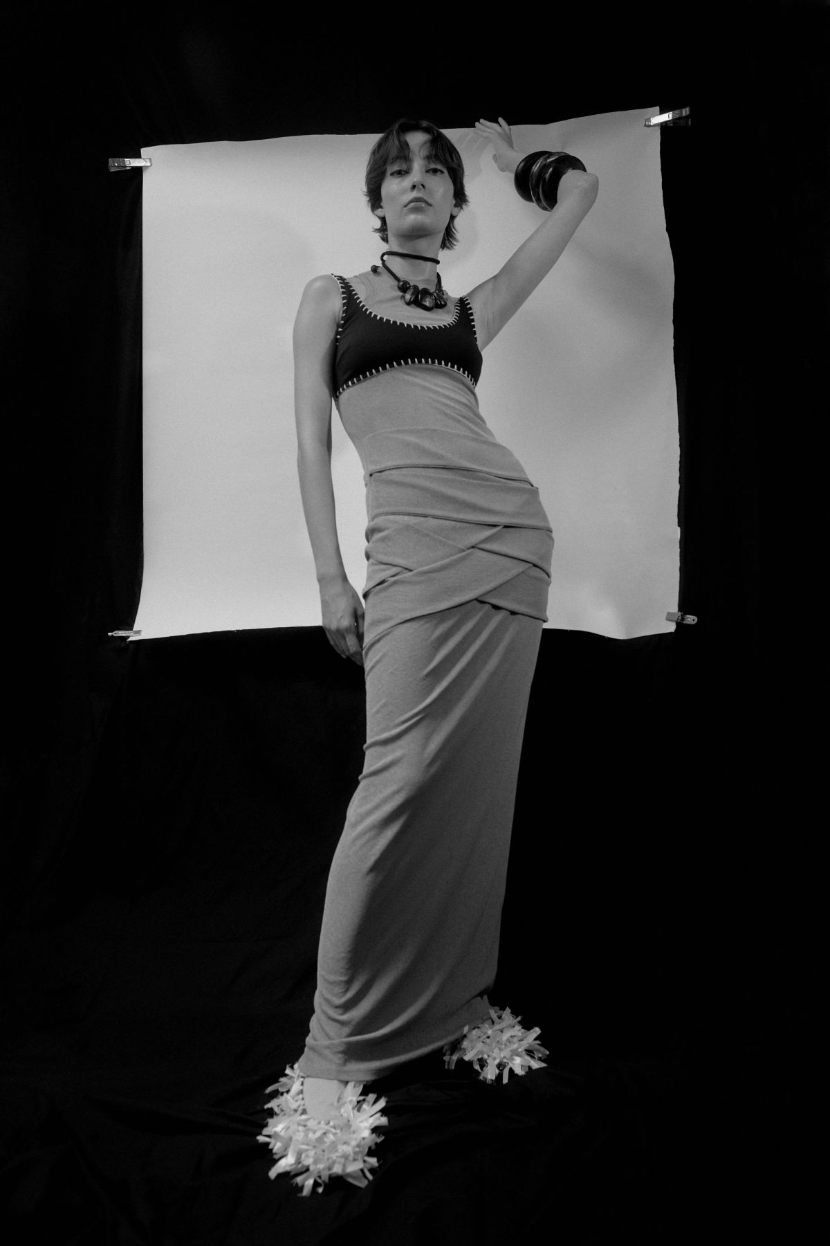 model wearing a dress in front of a black background