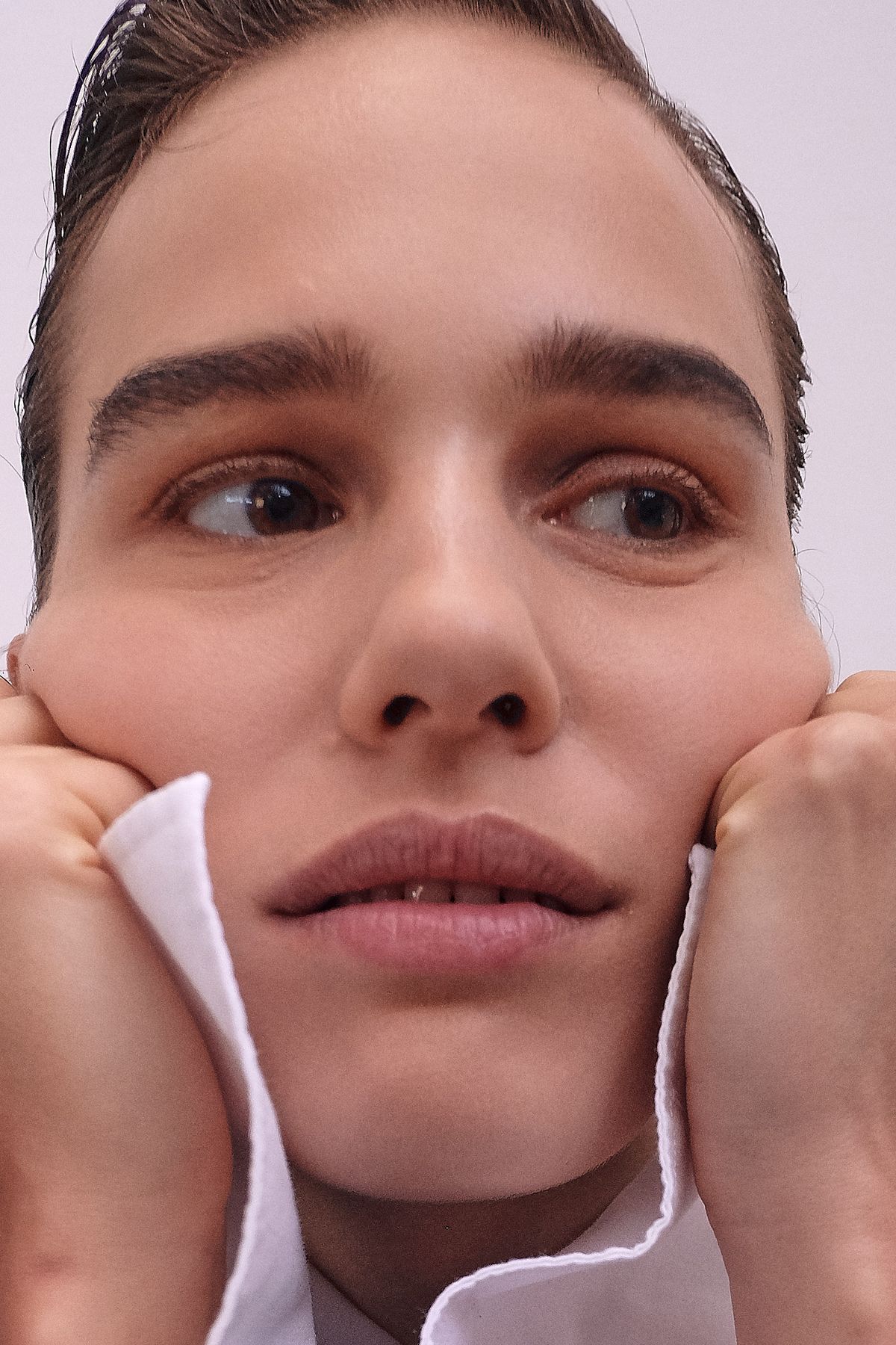 Close up of model with natural make up and sleeves near her face