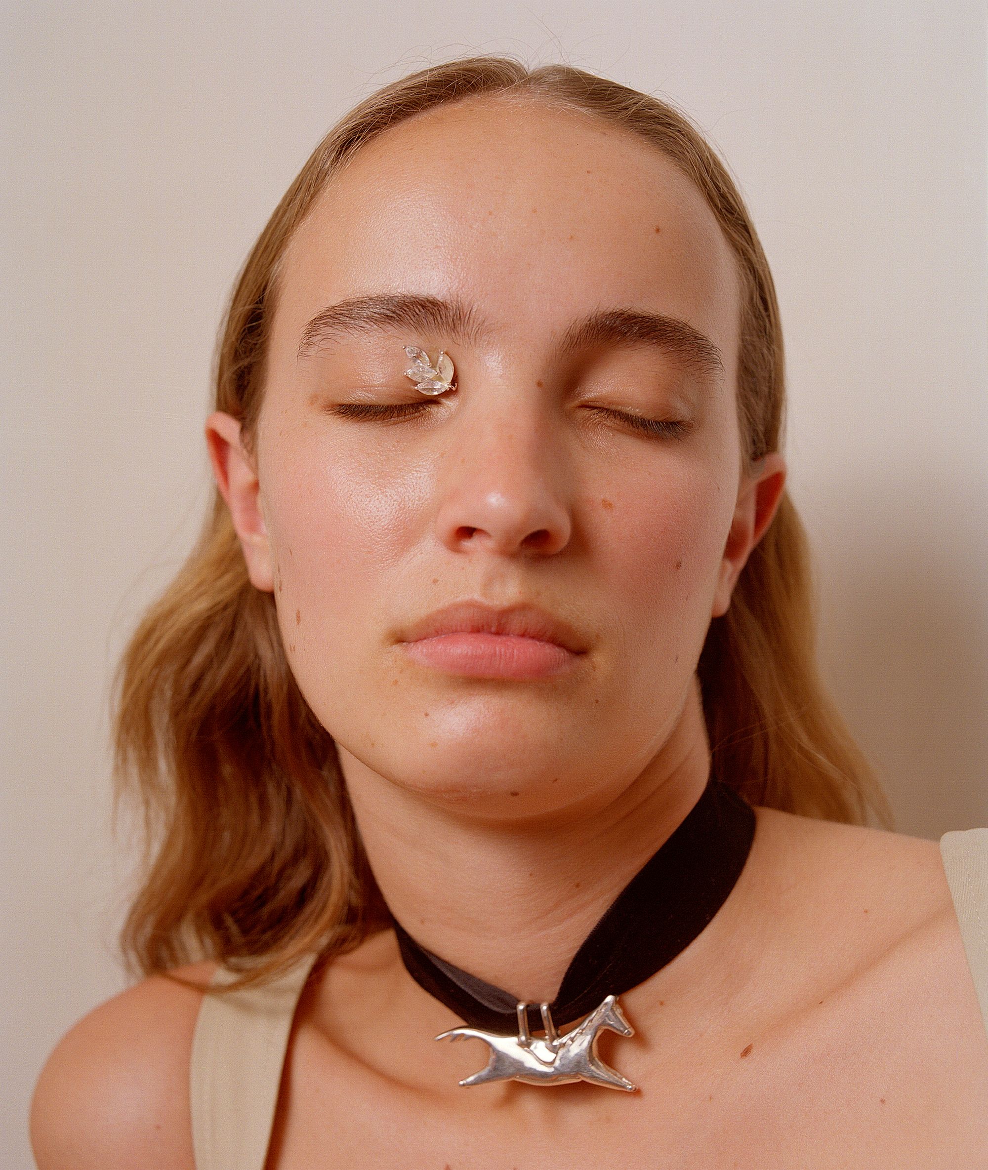 A women with jewellery balancing on her eye