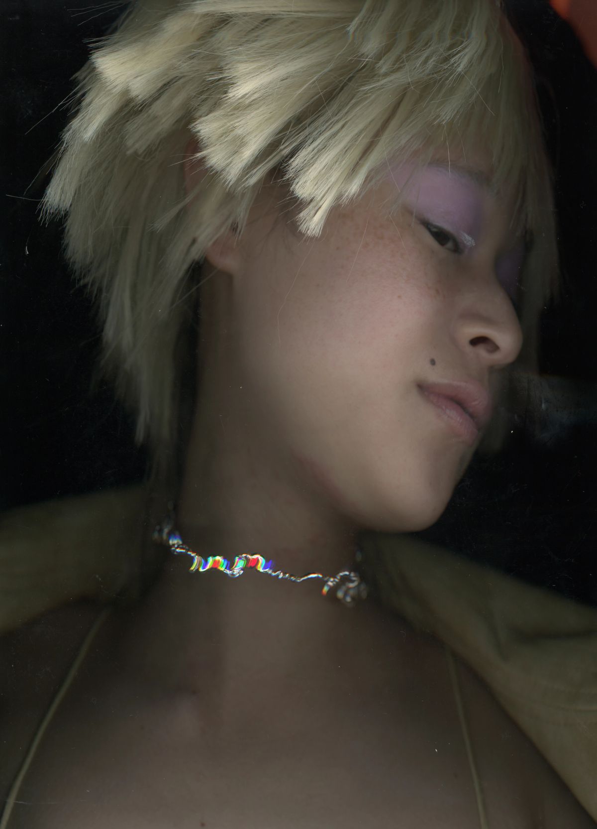 scan of womens face with necklace and pink eyeshadow blonde wig