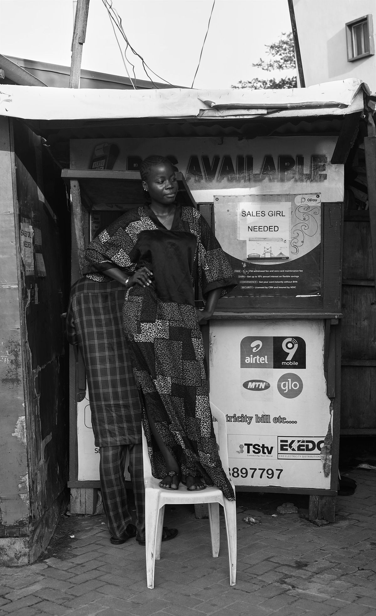woman standing on a chair in front of her POS station