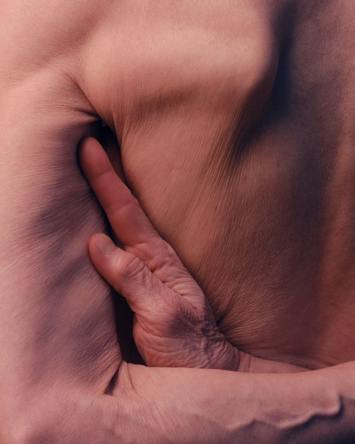 close up of the hand ticked into the back of the armpit on a womens body