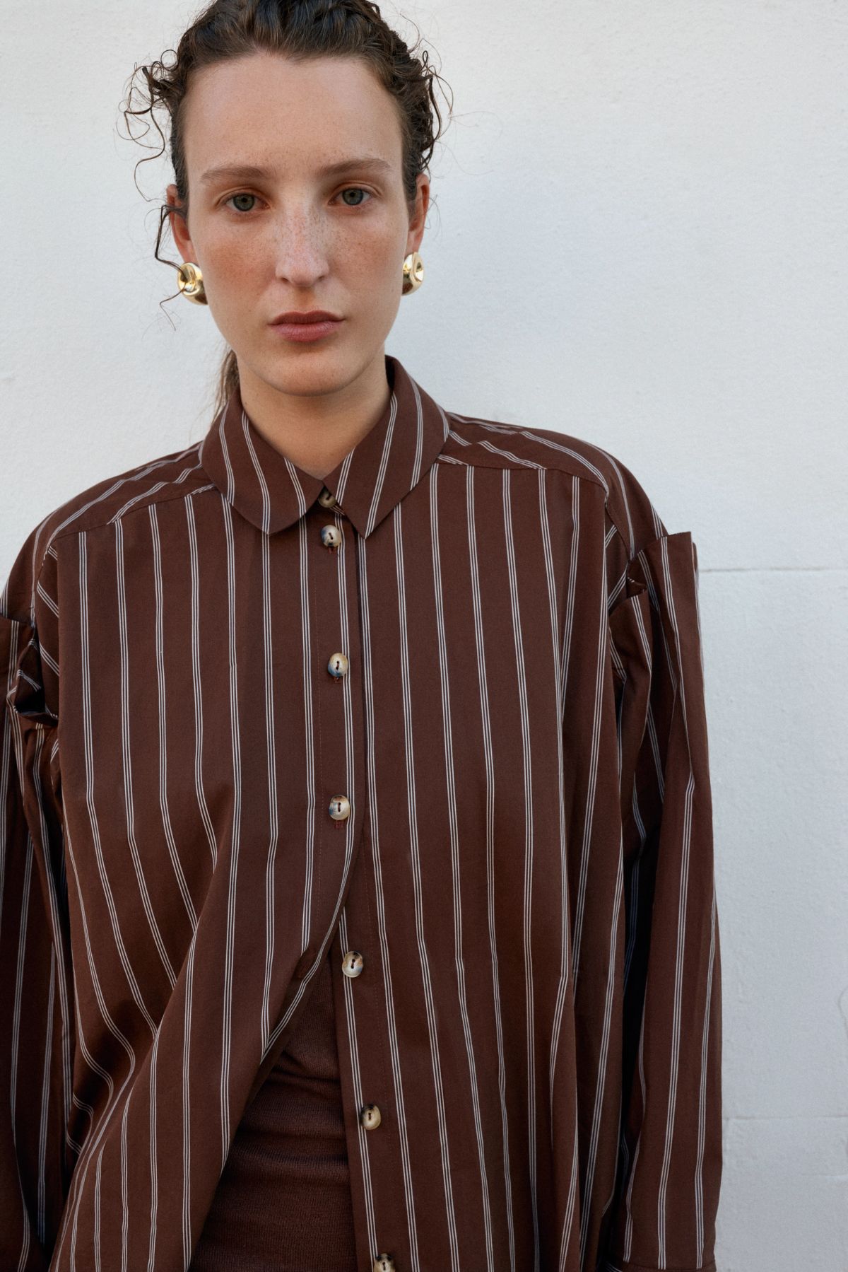Woman standing in striped shirt