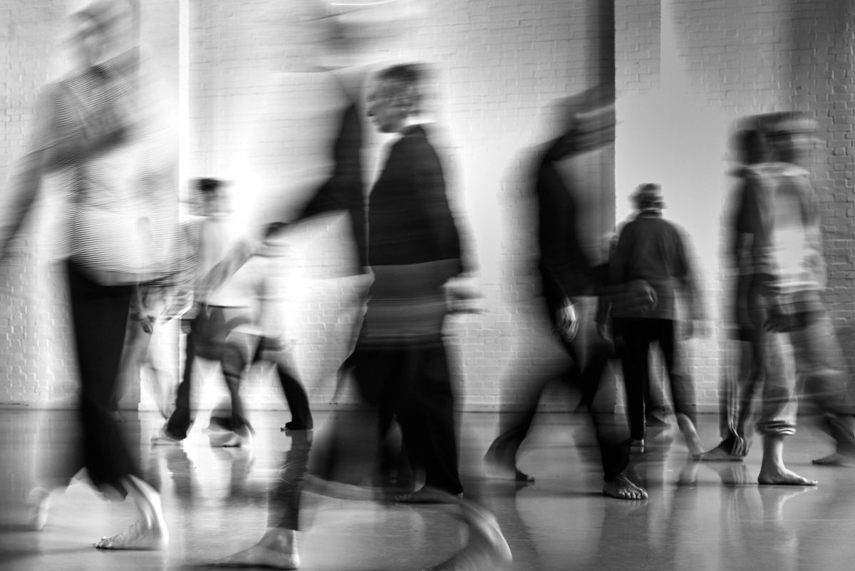 blurred images of dancers moving through a space 