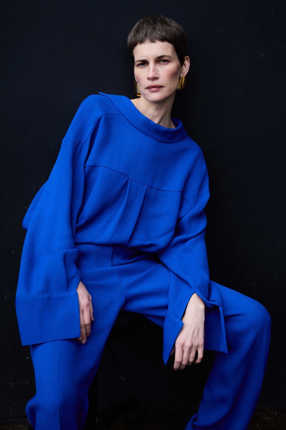 Model wearing Yves Klein Blue coord sitting