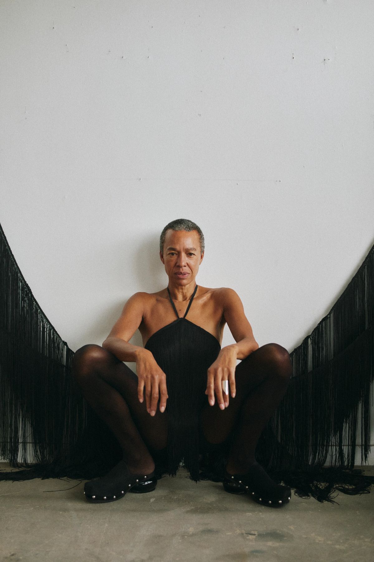 women crouching wearing a black dress
