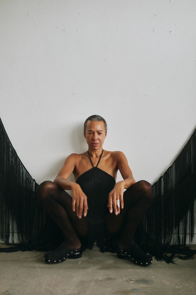 women crouching wearing a black dress