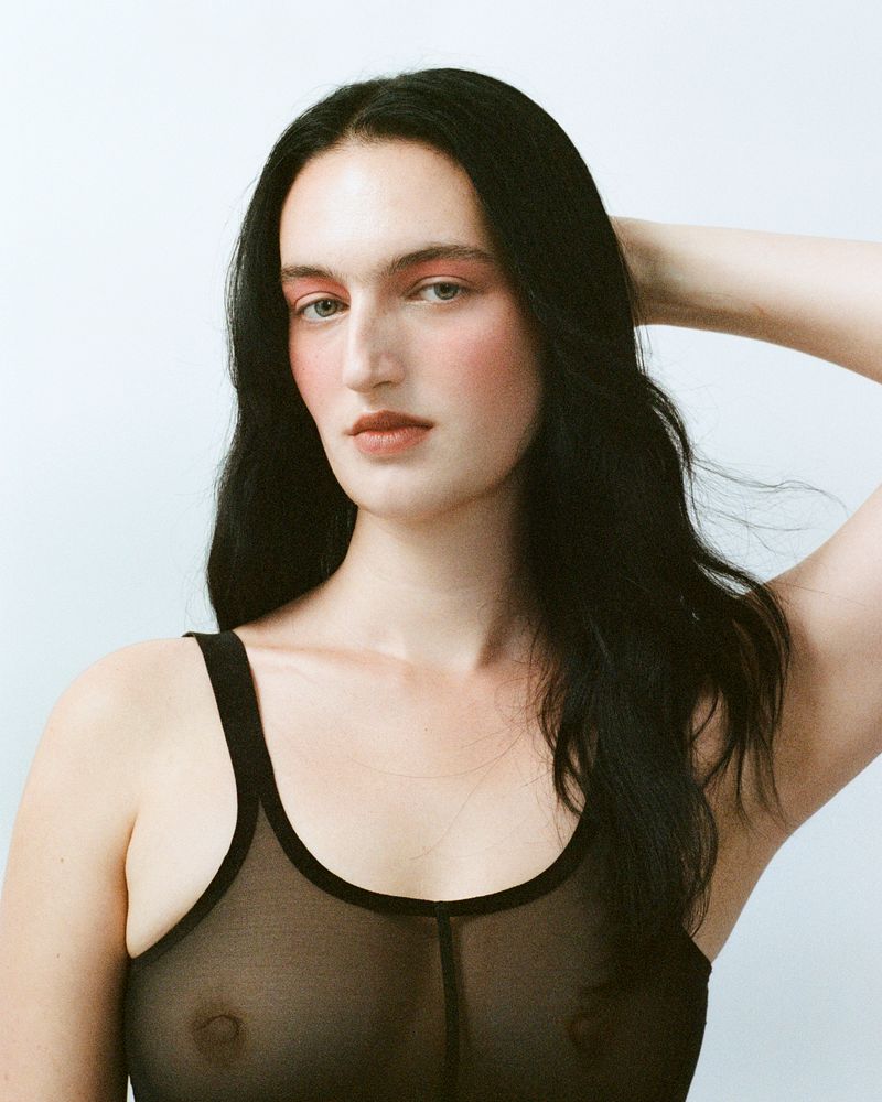 model with see through black top