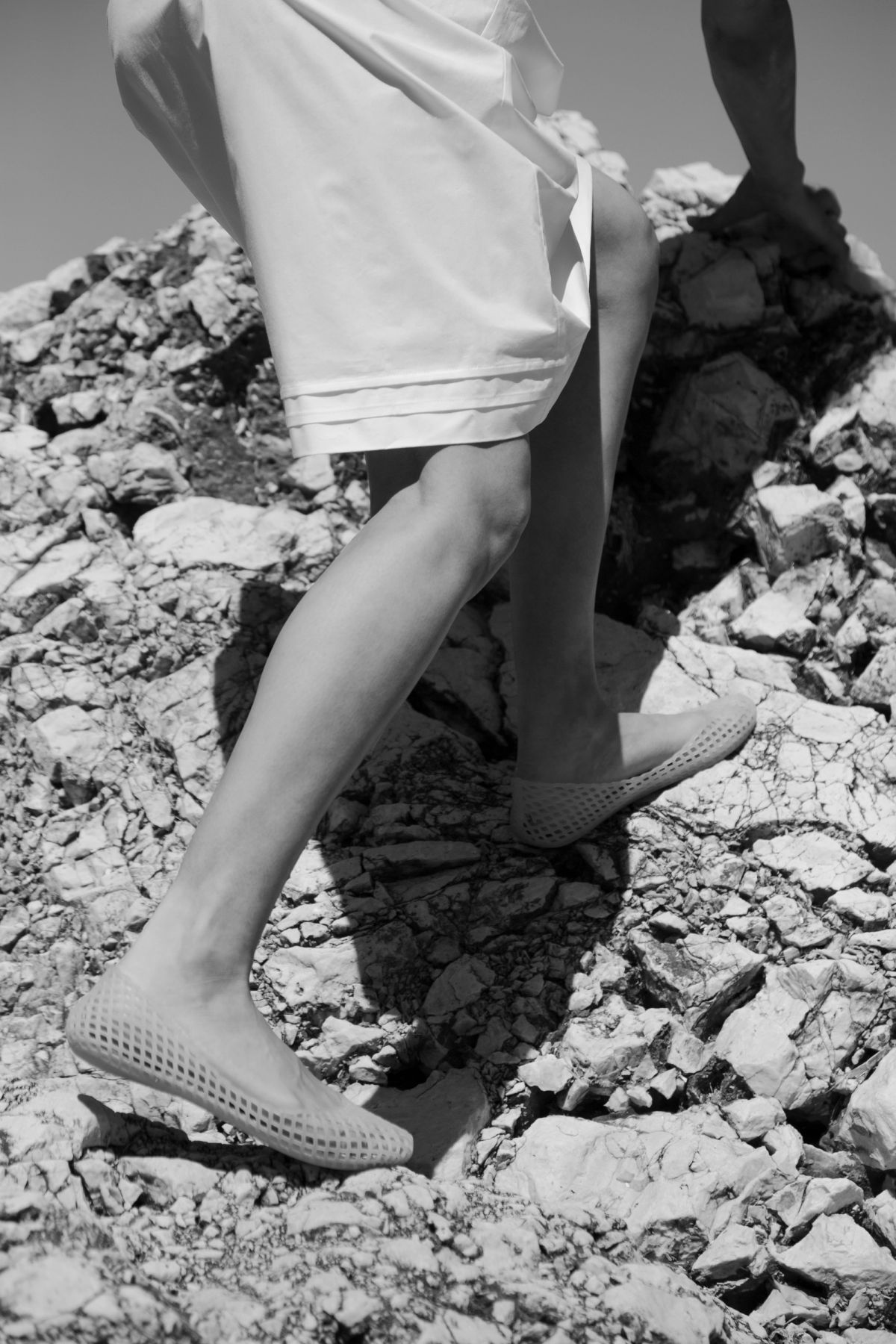 Woman climbing up rocks
