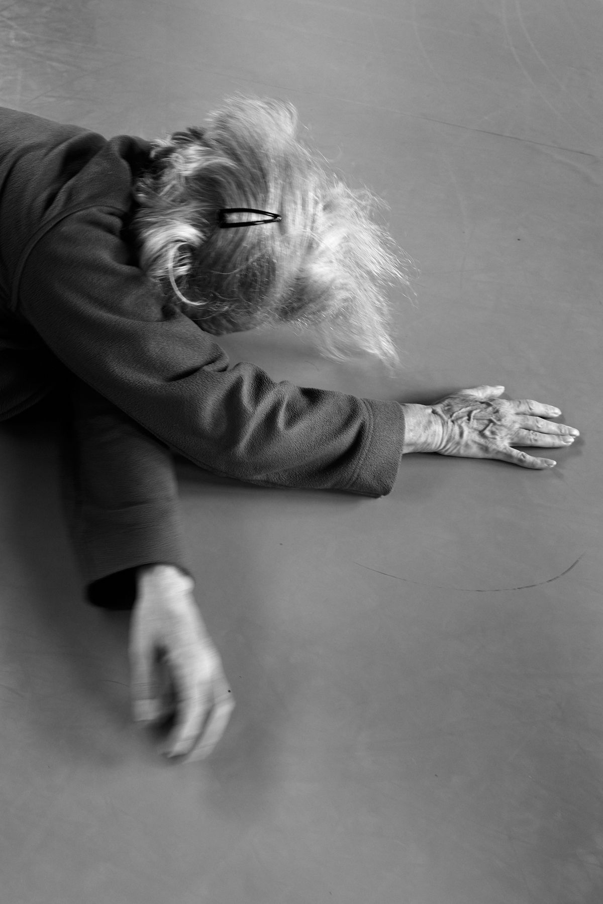 women rolling on the floor with hair clip in her hair