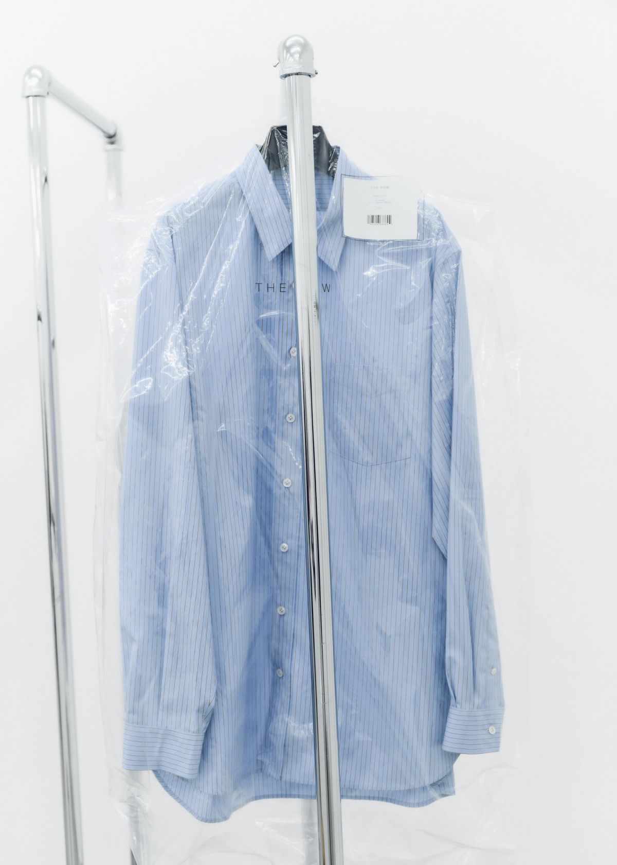 blue stripped Shirt in plstic hanging bag on a rail