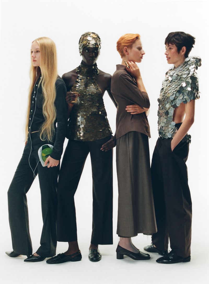 4 models facing different directions gossiping on a white background