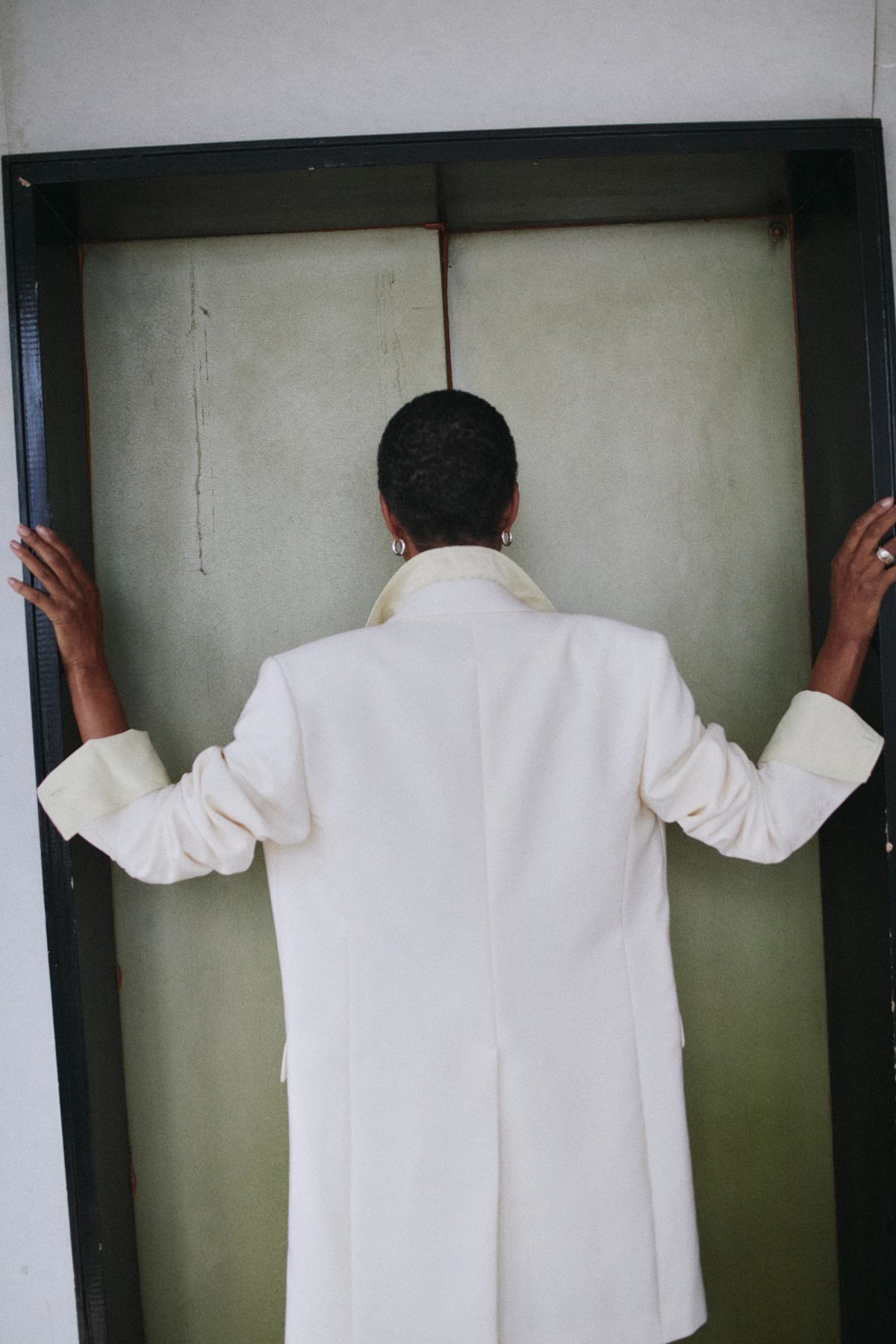women wearing white coat with back to camera