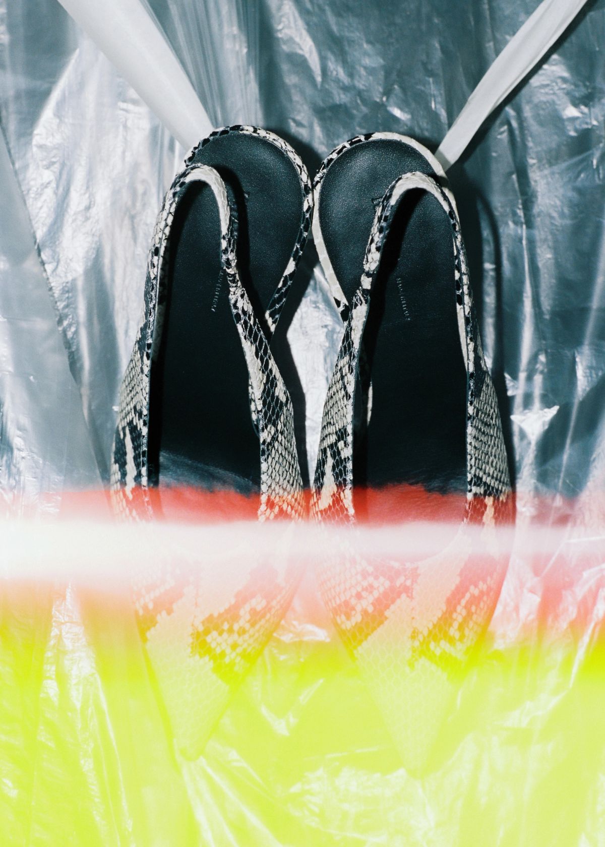 Snake print sling back heels on plastic with film distortion