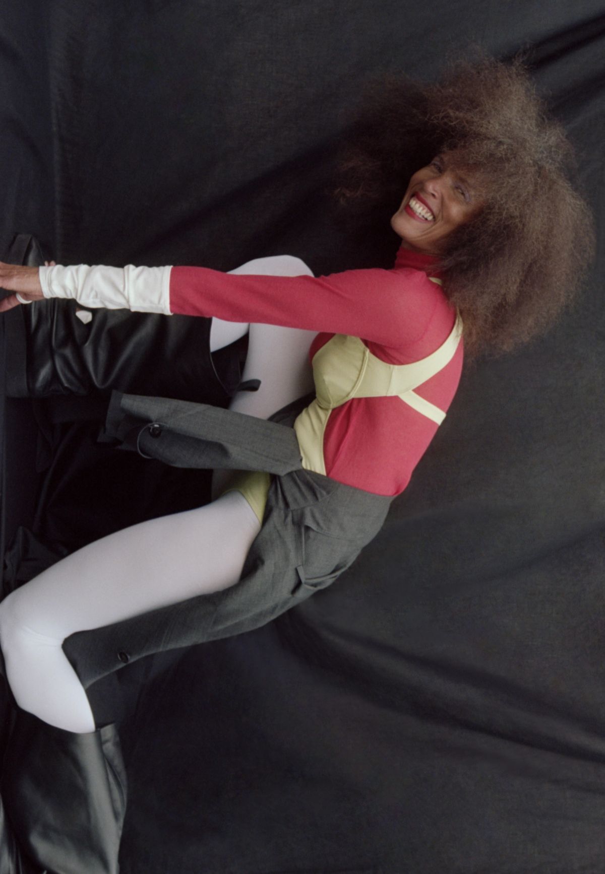 model bending across the shot and smiling