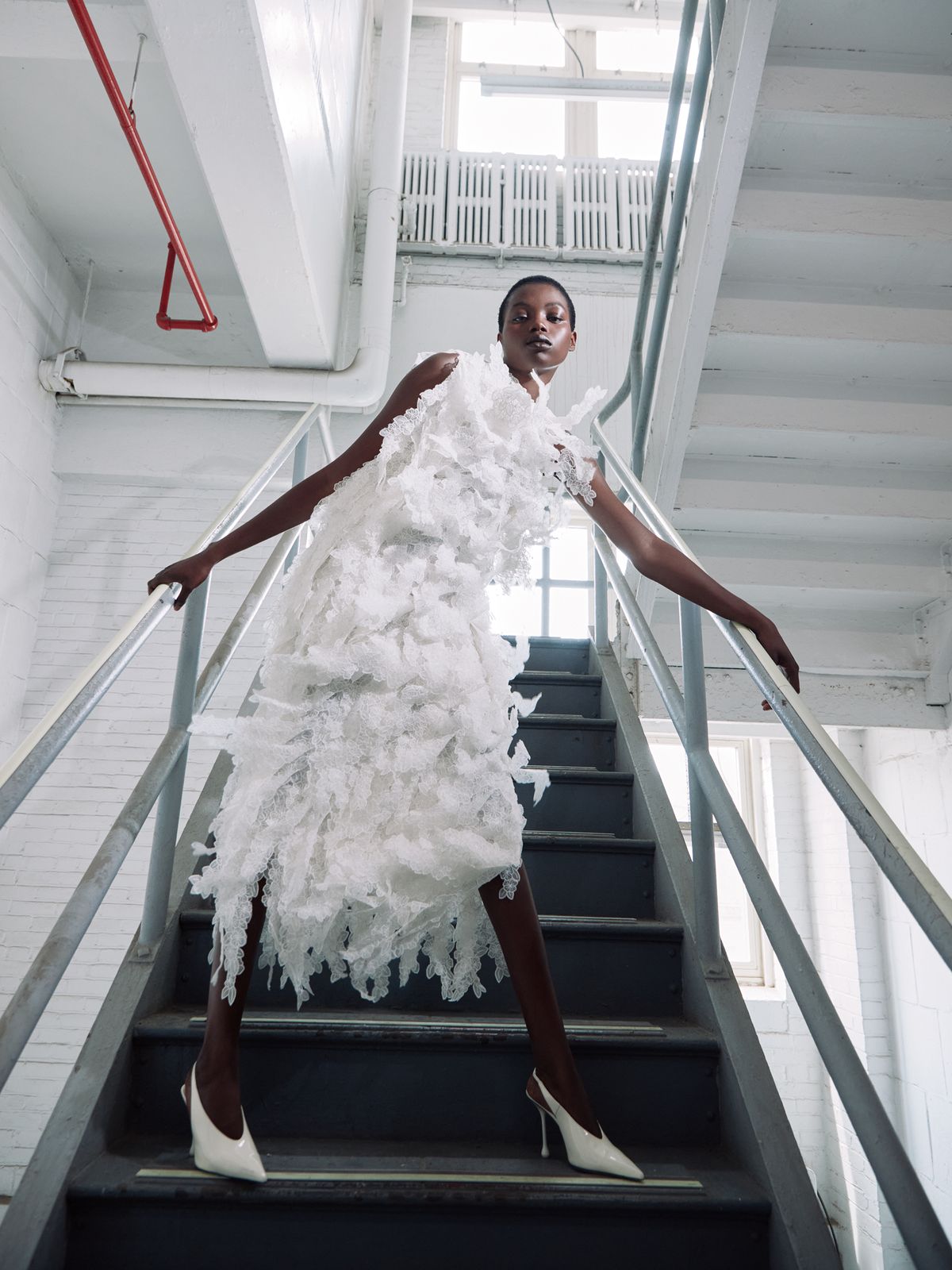 Women blocking a staircase with her body wearing white