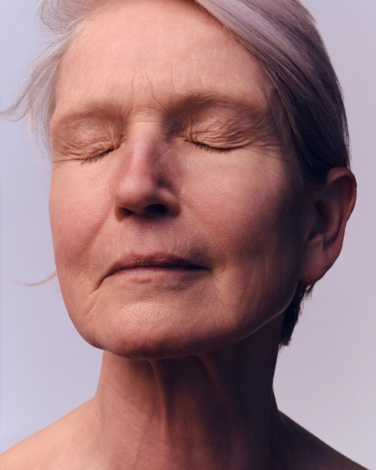 a soft smile across a womens face close up