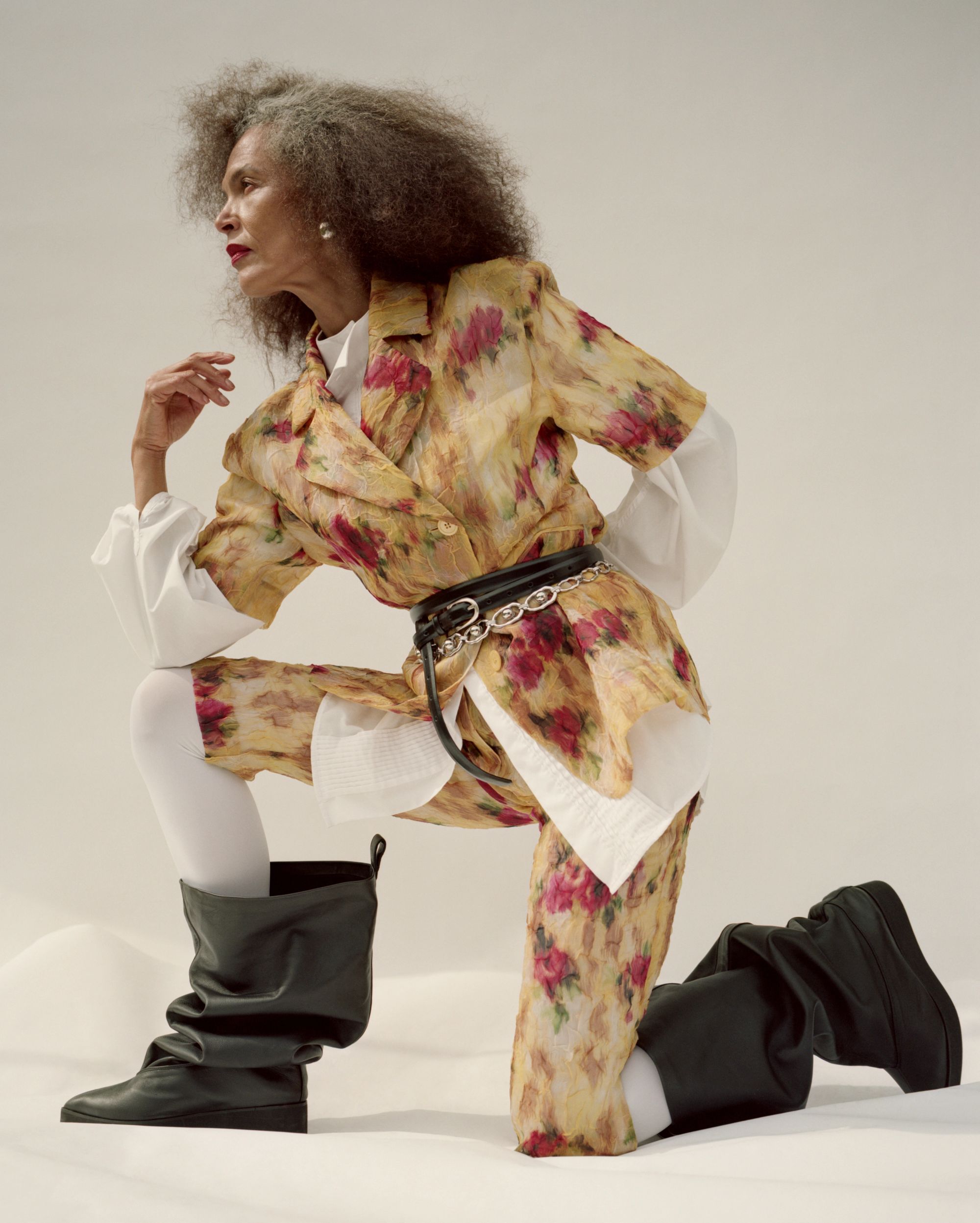 Women wearing florals and black books in a studio setting