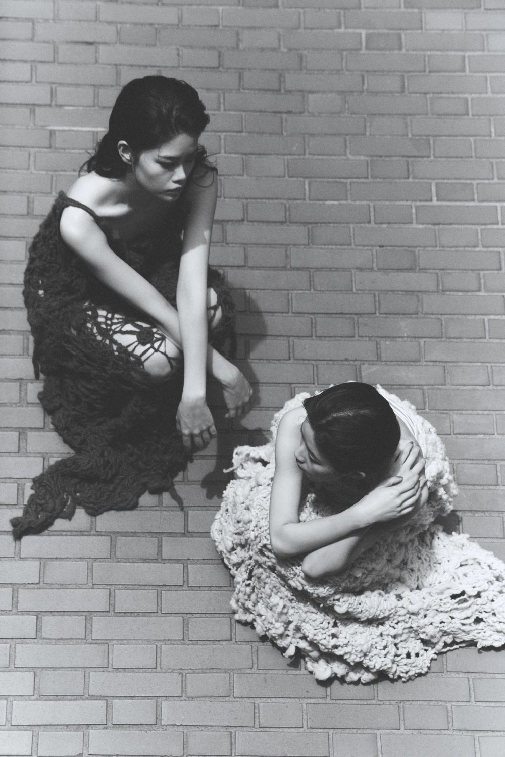 two models shot from above wearing knitted dresses