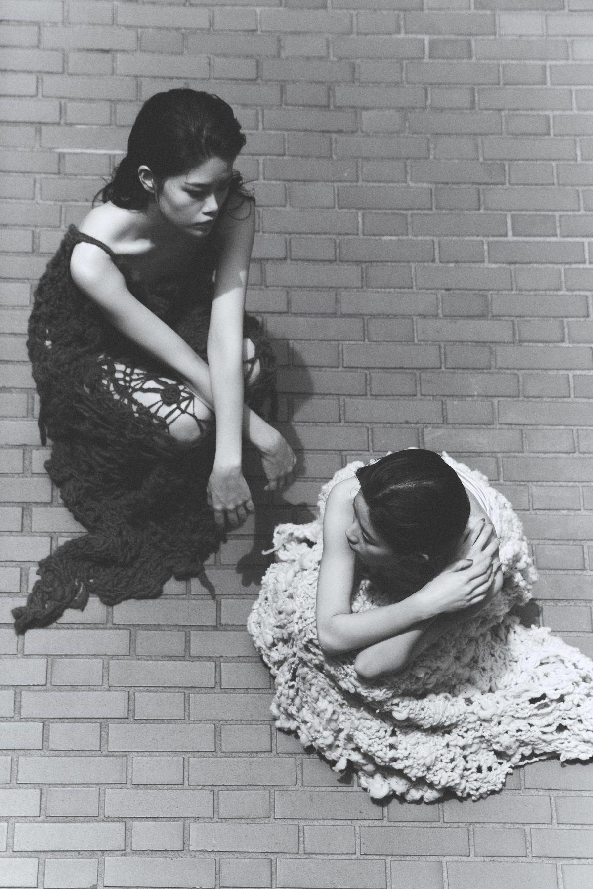 two models shot from above wearing knitted dresses