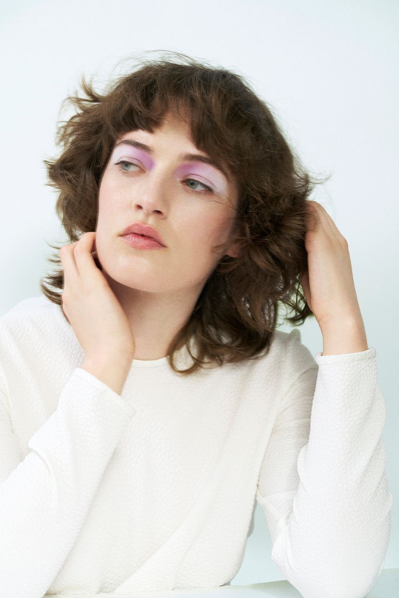 model in white with white eyeshadow on a white background