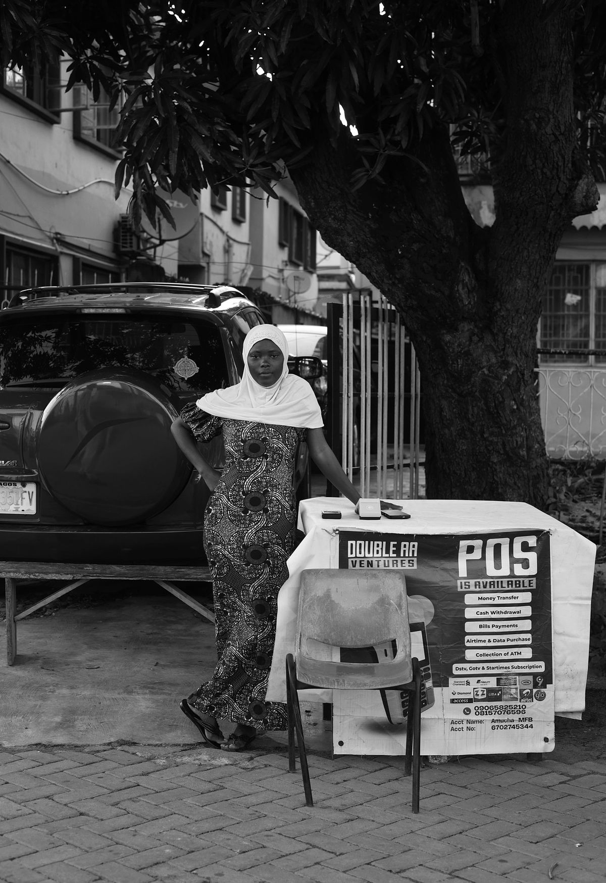 Young Nigerian Hijabi standing at her POS station