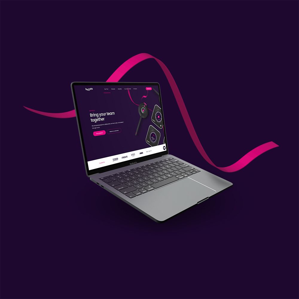 Laptop floating on a purple background and pink ribbon with VoCoVo S5 Pro site on the screen