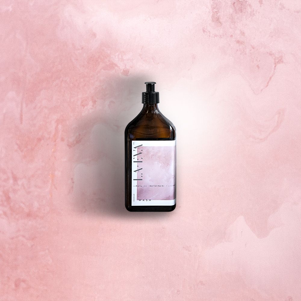 La Eva product bottle placed against a soft pink watercolour background, highlighting the product's label design