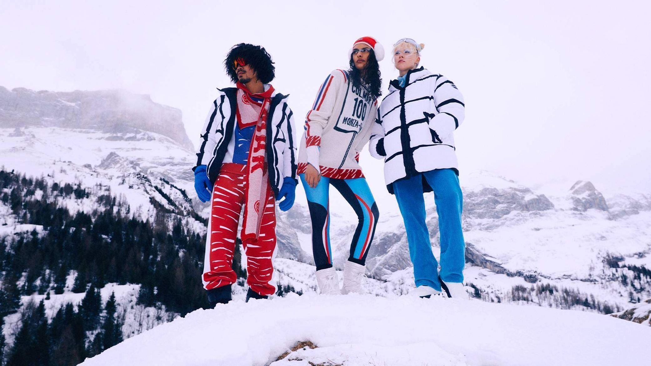 three people in the mountains with snow