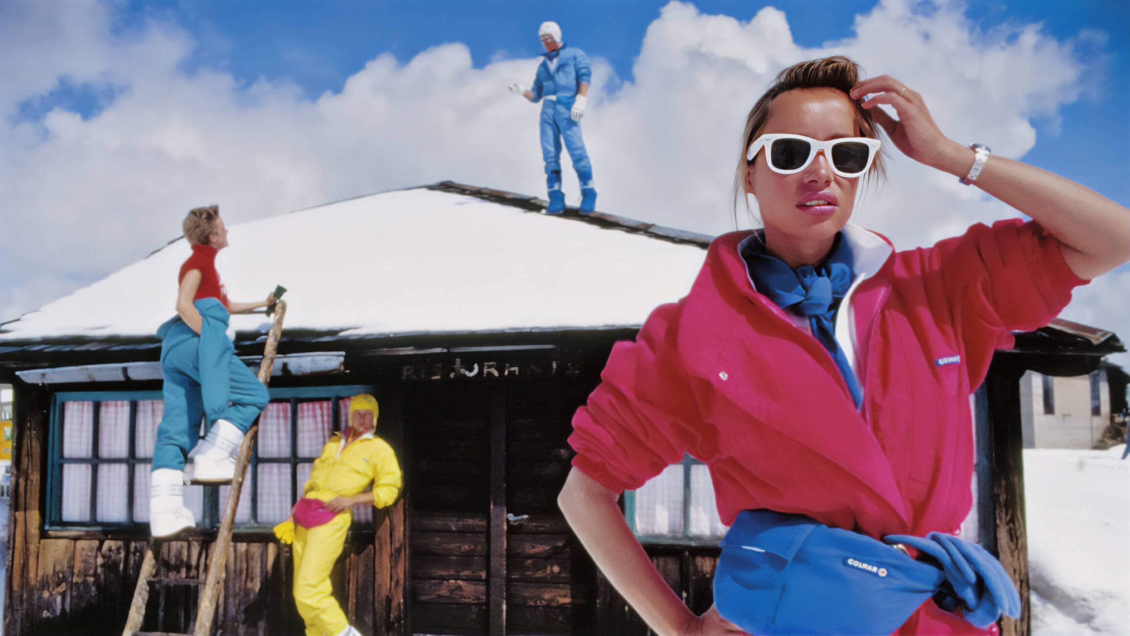 group of kids outside a snowy cabin