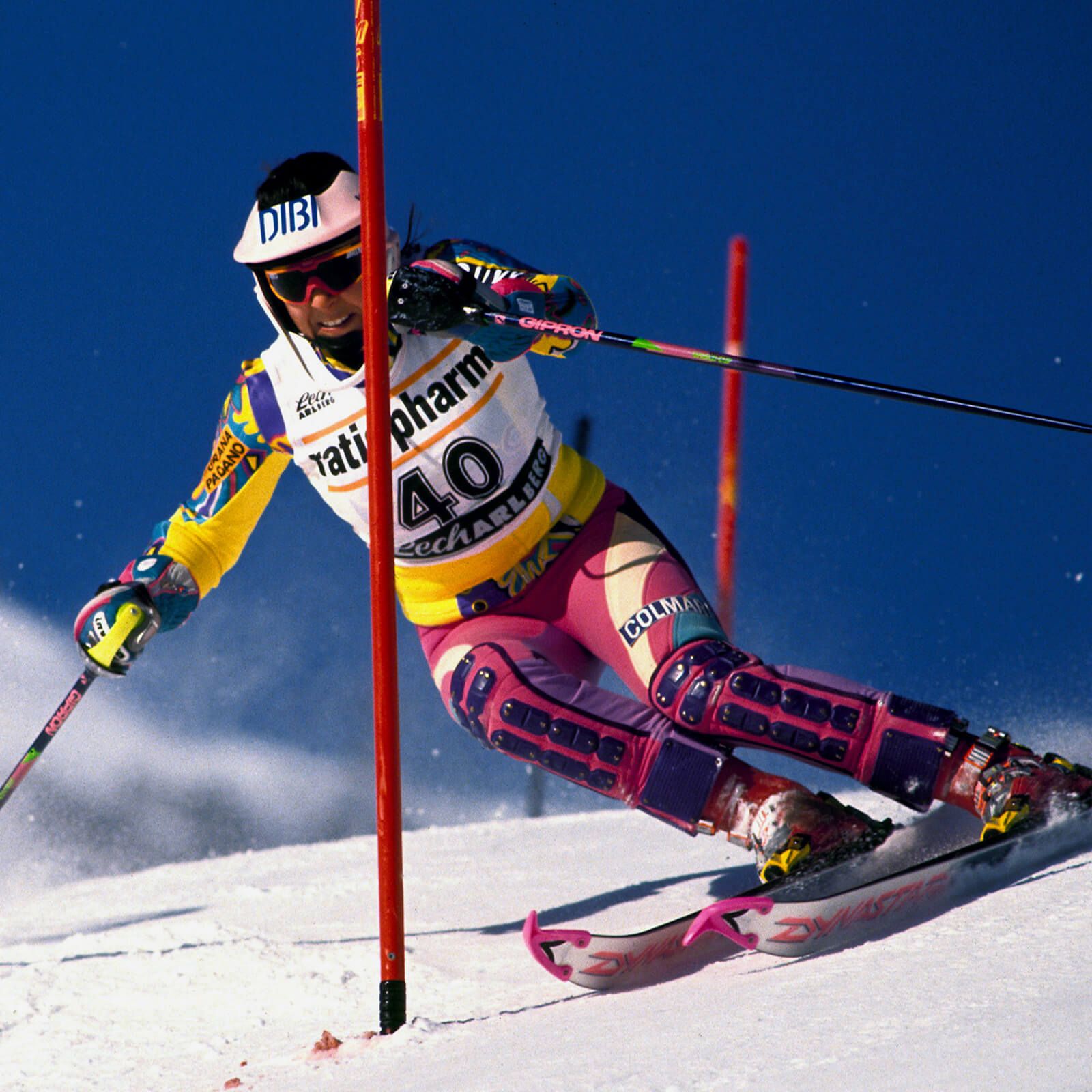 Colmar skier shooting with green and yellow suit