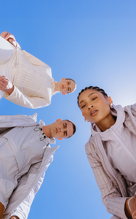 three people looking at the camera for a colmar shooting, with blue sky as a background