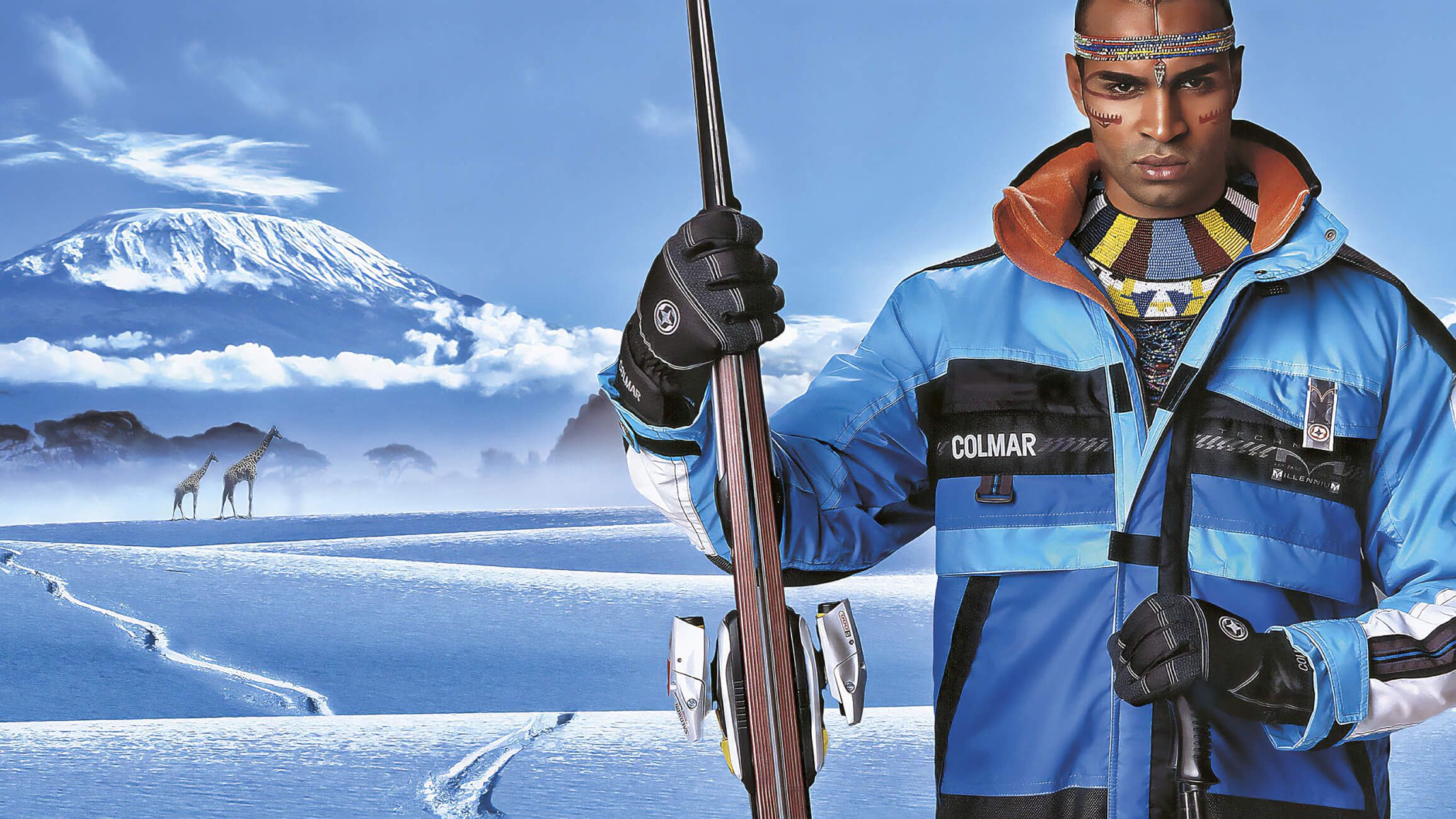 man in blue jacket with mountain in background