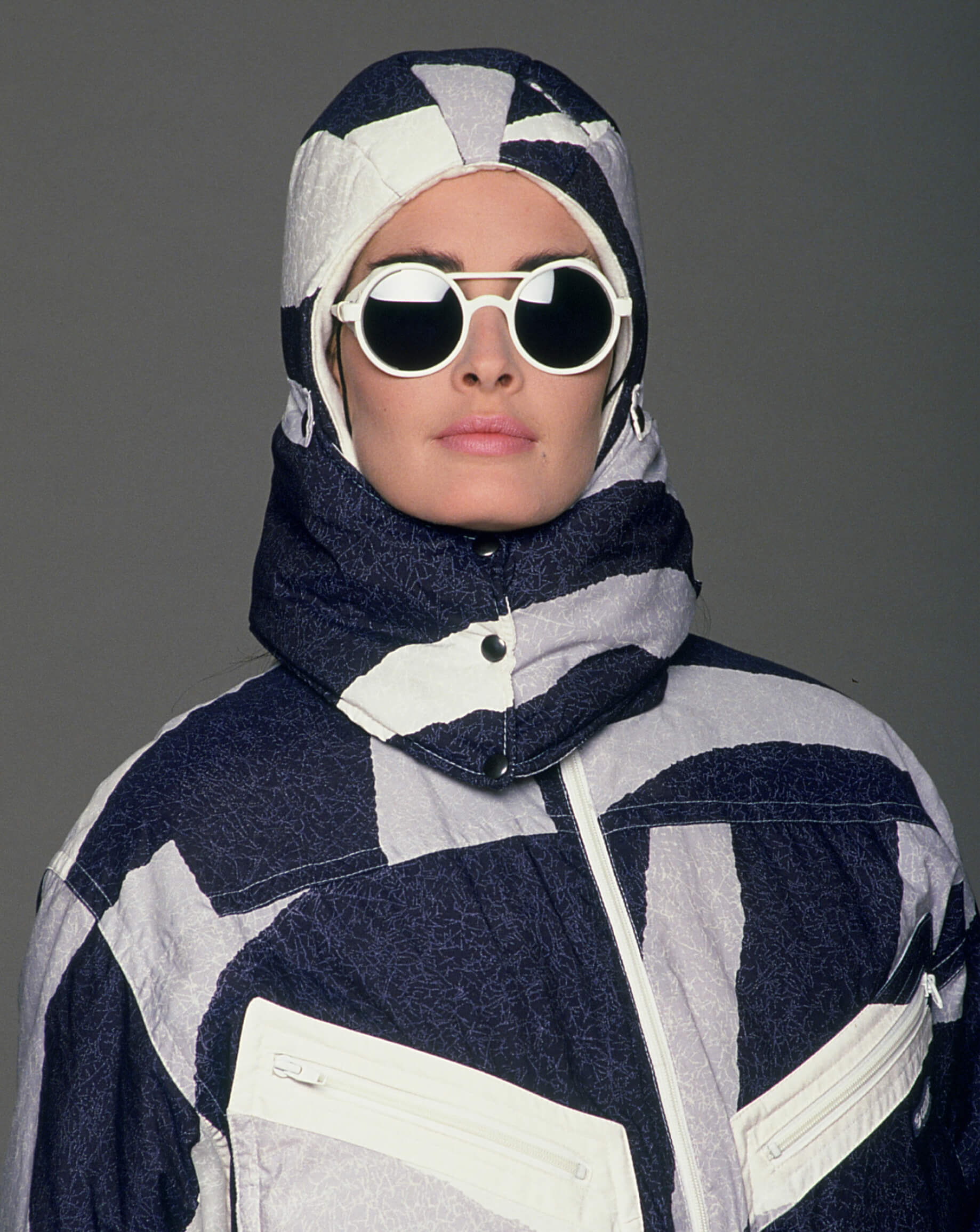 close-up of a woman with a down jacket and sunglasses