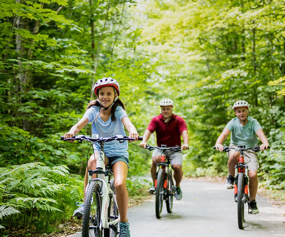 A family riding bicycles on a bike path.
