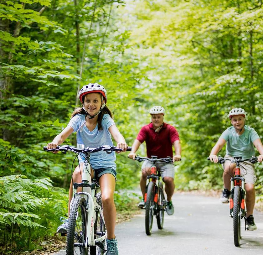 A family riding bicycles on a bike path.