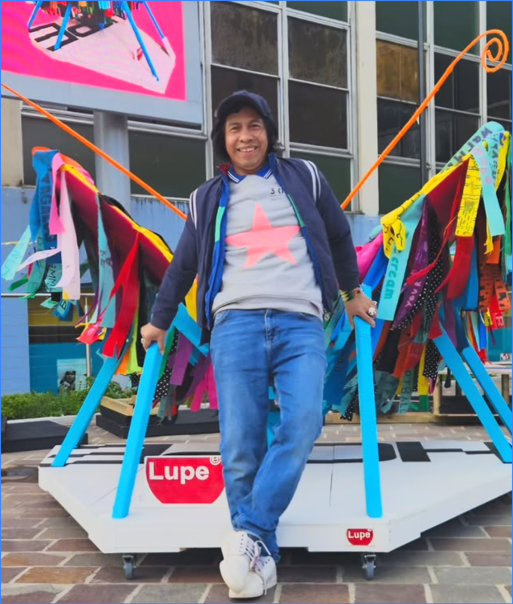 Portrait of Lupe Velazquez with his 3D butterfly artwork