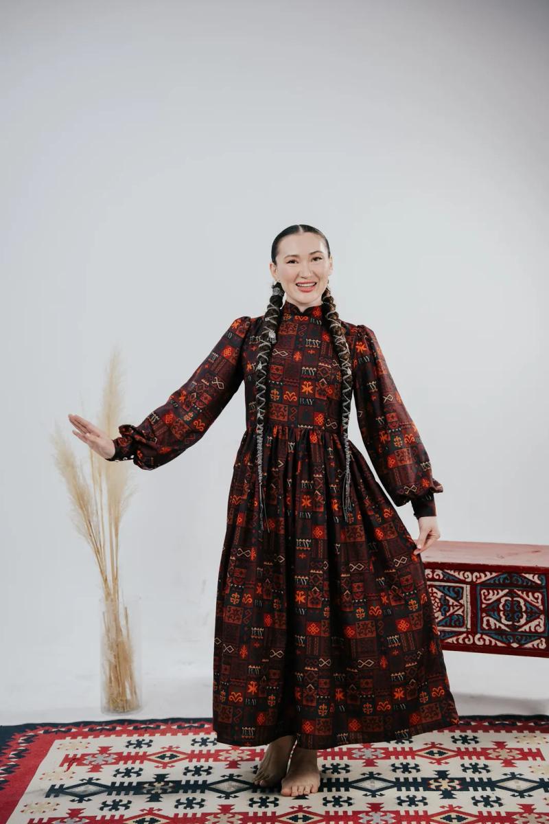Banu Gaidar in a dark red dress, full length