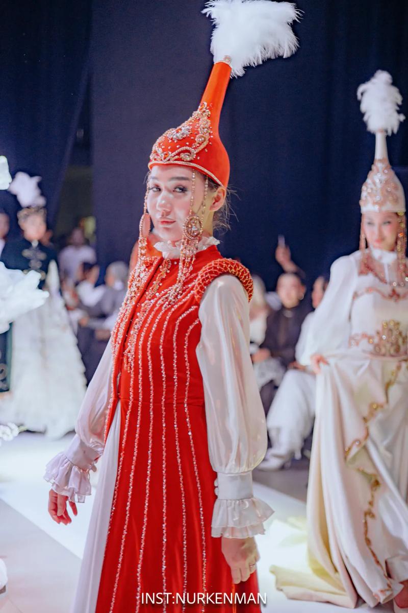 Models in red and white national dresses and headdresses