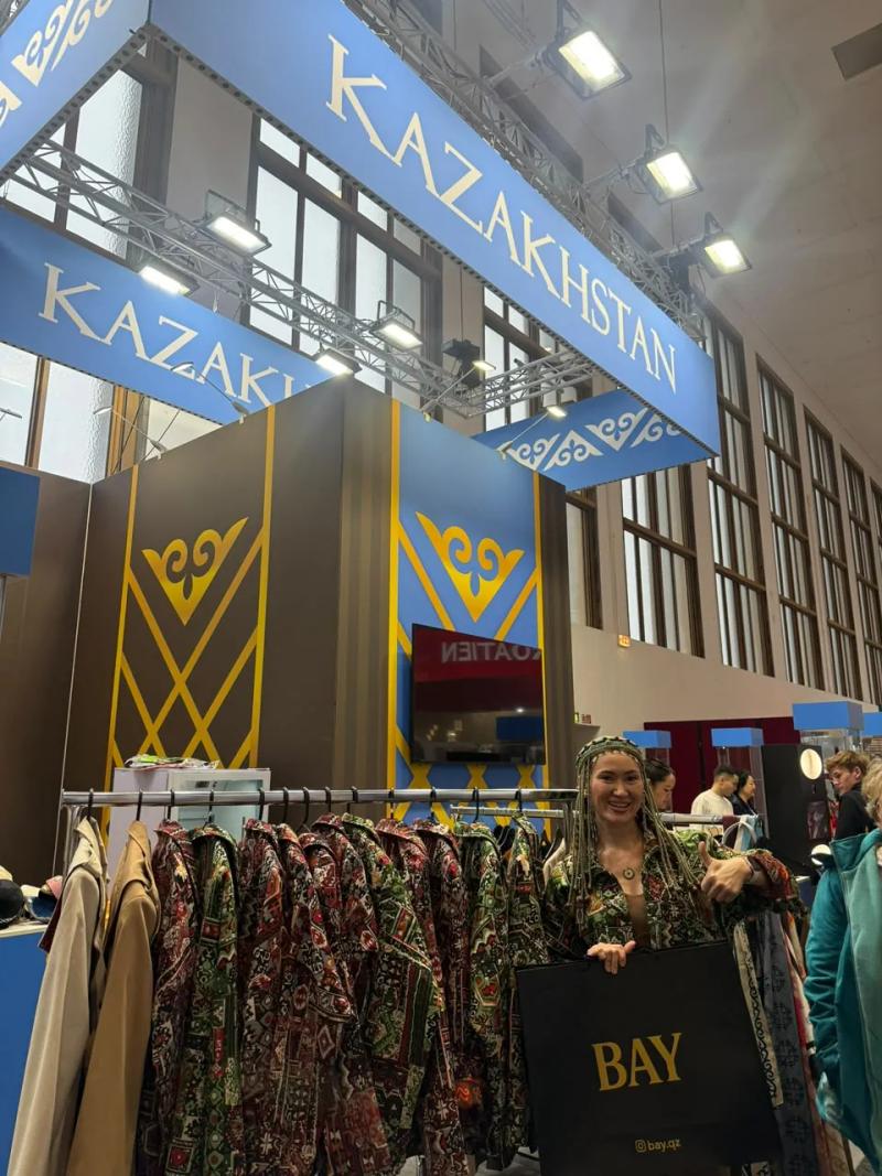 Banu Gaidar by a rail of BAY bombers at the Kazakhstan stand