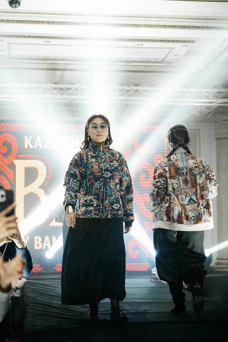 Two models in BAY bombers on the runway