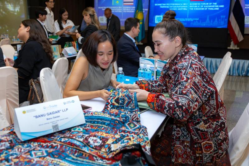 Banu Gaidar shows a BAY bomber to a guest at her table