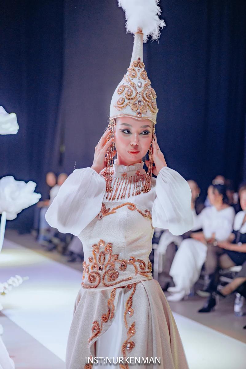 Model in a white national dress and a saukele headdress