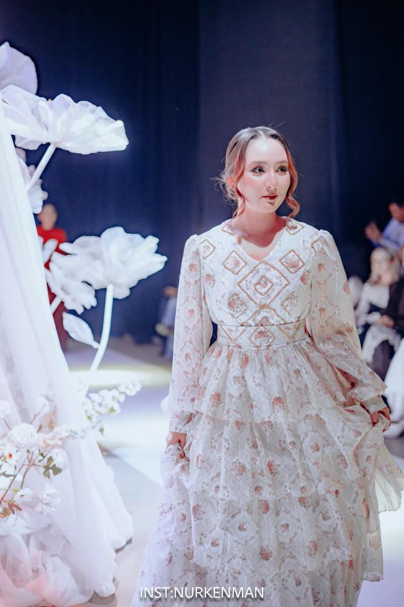 Model in a white embroidered dress