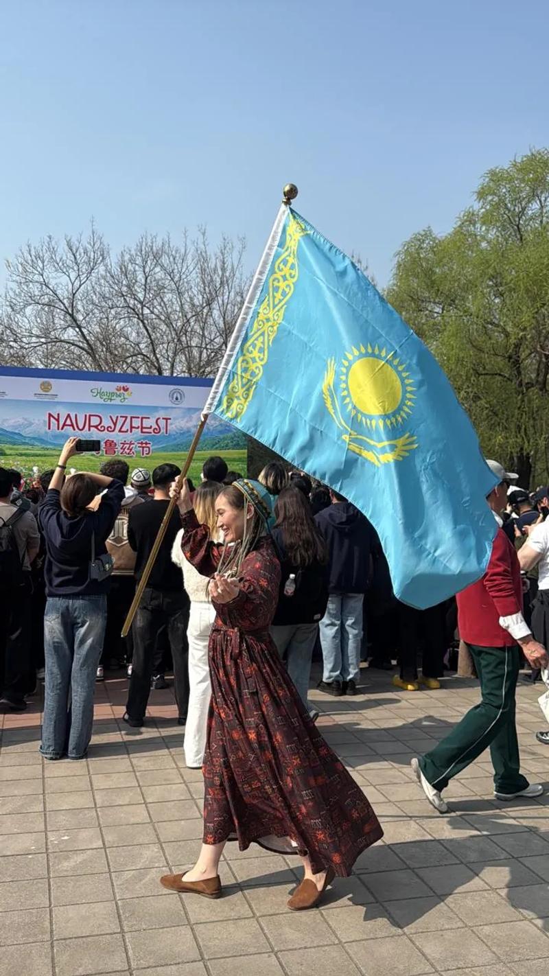 Banu Gaidar carries the flag of Kazakhstan at the celebration