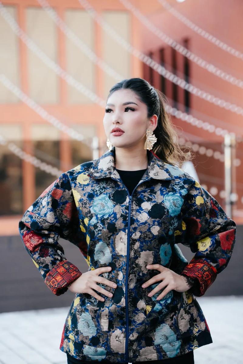 Model in a bomber with a floral pattern, outdoors