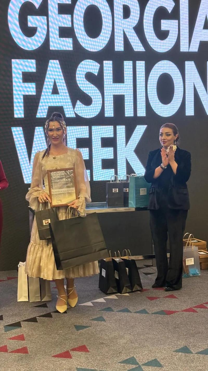 Presentation of the participation certificate on stage at Georgia Fashion Week
