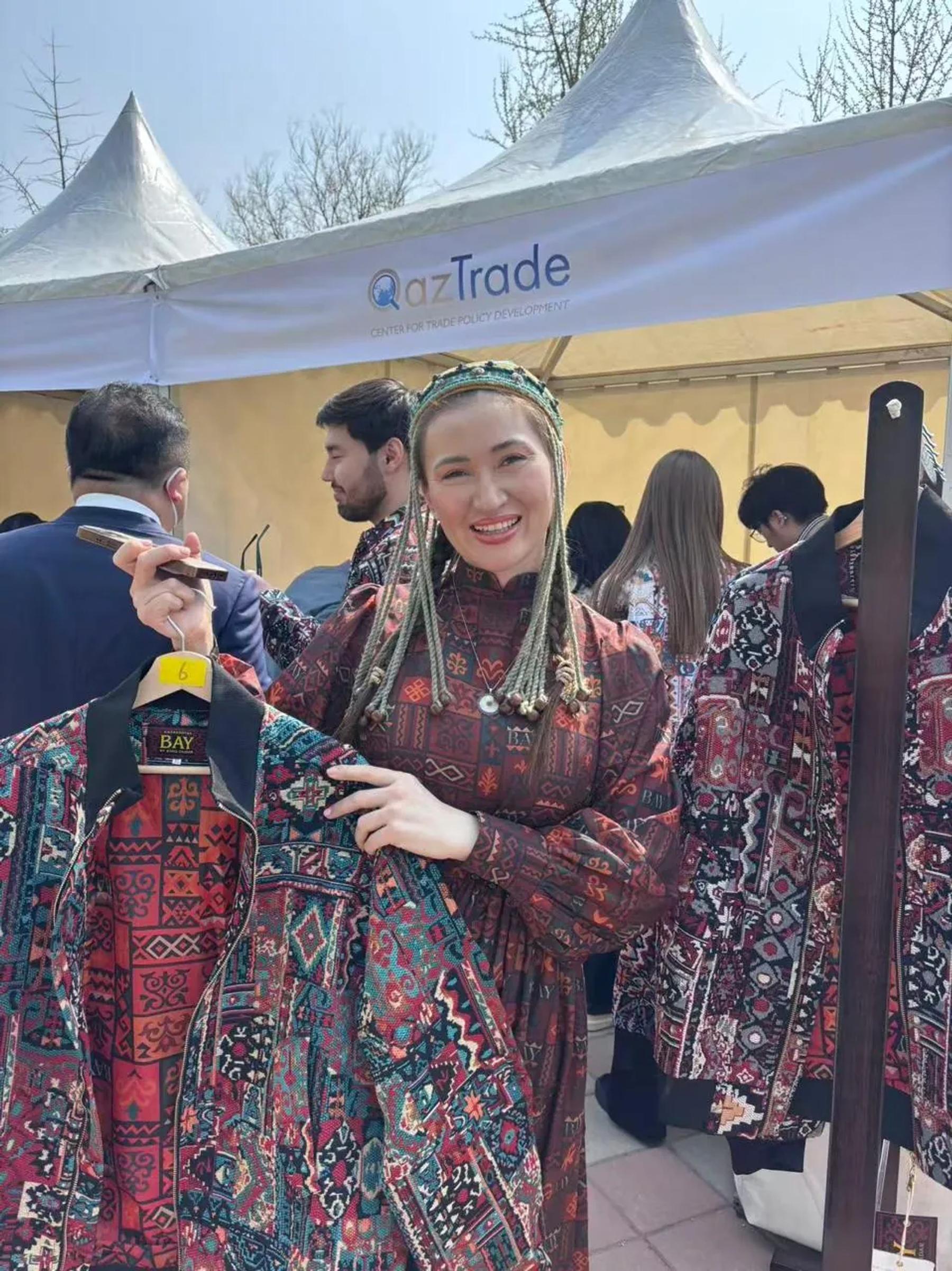 Banu Gaidar shows a BAY bomber by the QazTrade tent